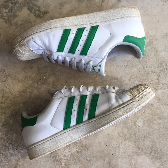 white adidas trainers with green stripes